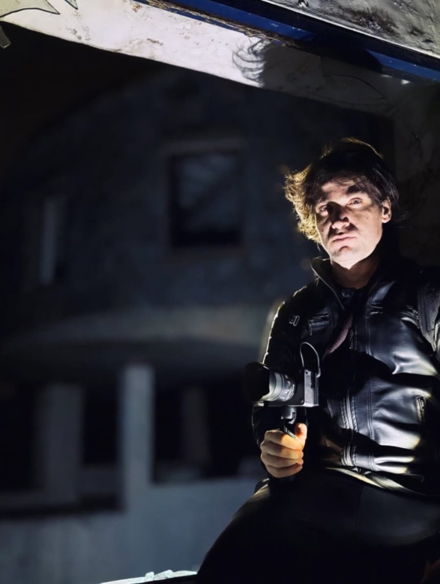Nicolás Rodríguez of Shaka Paranormal holding a camera during an investigation in an abandoned building